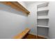 Walk-in closet with built-in shelving, a clothes rod, and a built-in bench, offering ample storage at 57 River Birch Ln., Pawleys Island, SC 29585