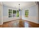 Bright dining room with hardwood floors, wainscoting, and large windows providing ample natural light at 57 River Birch Ln., Pawleys Island, SC 29585