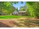 Charming home with a welcoming front porch, American flag, and green lawn at 57 River Birch Ln., Pawleys Island, SC 29585
