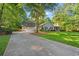 Charming home with a three-car garage, long driveway, and mature trees at 57 River Birch Ln., Pawleys Island, SC 29585
