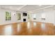 Bright, spacious living area with hardwood floors, fireplace, and ample natural light at 57 River Birch Ln., Pawleys Island, SC 29585