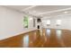 Large living room showcasing a fireplace, hardwood floors, and white wainscoting and trim at 57 River Birch Ln., Pawleys Island, SC 29585