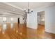 Open-concept living room featuring hardwood floors and seamless transition to kitchen area for modern living at 57 River Birch Ln., Pawleys Island, SC 29585