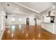 Spacious living room with hardwood floors, fireplace, and seamless access to kitchen and dining areas at 57 River Birch Ln., Pawleys Island, SC 29585