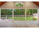 Covered patio featuring a wooden floor and railings and providing great natural light and views of the backyard at 57 River Birch Ln., Pawleys Island, SC 29585