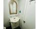 Bathroom features a single sink vanity with storage, a toilet, and mosaic-framed mirror at 6001 - 1864 S Kings Hwy., Myrtle Beach, SC 29575