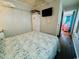 Comfortable bedroom featuring a queen bed, TV, closet space, and nautical themed decor at 6001 - 1864 S Kings Hwy., Myrtle Beach, SC 29575