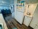 Bright kitchen features wood flooring, white appliances, and an eat-in bar area with seating at 6001 - 1864 S Kings Hwy., Myrtle Beach, SC 29575