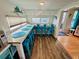 Eat-in kitchen featuring bar-style seating, wood flooring, and bright natural light at 6001 - 1864 S Kings Hwy., Myrtle Beach, SC 29575