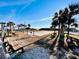 Outdoor seating area near the beach with benches, picnic tables, and palm trees at 6001 - 1864 S Kings Hwy., Myrtle Beach, SC 29575
