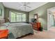 Tranquil bedroom featuring a ceiling fan, a large window with natural light, and ample closet space at 601 Hillside Dr. # 4424, North Myrtle Beach, SC 29582