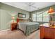 Comfortable bedroom featuring a ceiling fan, a patterned bedspread, and two side tables with lamps at 601 Hillside Dr. # 4424, North Myrtle Beach, SC 29582