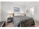 A calm bedroom featuring a queen bed with lamps, a seascape art piece and view into the bathroom at 601 Hillside Dr. # 4424, North Myrtle Beach, SC 29582