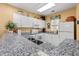 Bright kitchen showcasing granite countertops, white cabinetry, and modern appliances at 601 Hillside Dr. # 4424, North Myrtle Beach, SC 29582