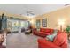 A vibrant living room with a comfortable red sofa and a scenic view from the sliding glass doors at 601 Hillside Dr. # 4424, North Myrtle Beach, SC 29582