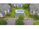 Aerial view showcasing the community pool, surrounding buildings, and parking lot at 601 Hillside Dr. # 4424, North Myrtle Beach, SC 29582