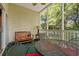 Inviting screened porch with a metal table and chairs, and a bench, overlooking lush trees at 601 Hillside Dr. # 4424, North Myrtle Beach, SC 29582