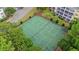 Overhead view of tennis courts surrounded by green foliage and yellow condominiums in the distance at 601 Hillside Dr. # 4424, North Myrtle Beach, SC 29582