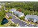 Aerial view of condos surrounded by lush greenery, ponds, and ample parking at 6015 Catalina Dr. # 332, North Myrtle Beach, SC 29582