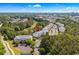 Aerial view of condo community near a lush green golf course and a tranquil pond at 6015 Catalina Dr. # 332, North Myrtle Beach, SC 29582