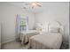 Bright bedroom with twin beds, neutral décor, and a window with a pleasant view at 6015 Catalina Dr. # 332, North Myrtle Beach, SC 29582