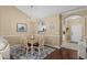 Dining area with wood table, hardwood floors, chandelier, and adjacent to the kitchen at 6015 Catalina Dr. # 332, North Myrtle Beach, SC 29582