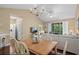 Dining area with a wood table, hardwood floors, chandelier, and views of the living room at 6015 Catalina Dr. # 332, North Myrtle Beach, SC 29582