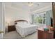 Serene bedroom with a king bed, tray ceiling, and natural light from the large window at 6015 Catalina Dr. # 332, North Myrtle Beach, SC 29582