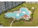 Aerial view of a large pool area with palm trees, umbrellas and lounge chairs at 6015 Catalina Dr. # 332, North Myrtle Beach, SC 29582