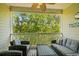 Relaxing covered porch featuring comfortable seating and a view of mature trees at 6015 Catalina Dr. # 332, North Myrtle Beach, SC 29582