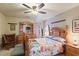 Comfortable bedroom featuring a floral patterned quilt, wooden bedframe, and ceiling fan at 605 Cavandish Dr., Myrtle Beach, SC 29588