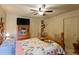 Bright bedroom featuring a floral patterned quilt, wooden bedframe, and ceiling fan at 605 Cavandish Dr., Myrtle Beach, SC 29588