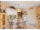 Bright breakfast nook with glass topped table, decorative lighting, and adjacent storage at 605 Cavandish Dr., Myrtle Beach, SC 29588