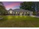 Charming single-story home boasting a well-kept lawn, shrubbery, and an attached garage, set against a colorful sunset at 605 Cavandish Dr., Myrtle Beach, SC 29588