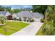 Well-maintained single-story home featuring a tidy front yard, long driveway, and attached garage at 605 Cavandish Dr., Myrtle Beach, SC 29588