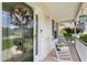 Inviting front porch with decorative glass front door, rocking chairs, and a welcoming atmosphere at 605 Cavandish Dr., Myrtle Beach, SC 29588