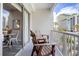 Cozy balcony with chairs with views of the surrounding cityscape, pool, and lush palm trees at 6803 N Ocean Blvd. # 228, Myrtle Beach, SC 29572