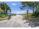 Discover beach access through a sandy path flanked by lush greenery, offering a tranquil escape to the ocean horizon at 6803 N Ocean Blvd. # 228, Myrtle Beach, SC 29572