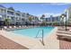 Outdoor pool area with lounge chairs offering a refreshing retreat with palm trees and inviting setting at 6803 N Ocean Blvd. # 228, Myrtle Beach, SC 29572