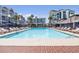 Large swimming pool with lounge chairs, palm trees, offering a refreshing and relaxing outdoor experience at 6803 N Ocean Blvd. # 228, Myrtle Beach, SC 29572