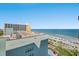 A breathtaking beach view from above features the ocean, sandy beach, and clear blue sky at 6804 N Ocean Blvd. # 1013, Myrtle Beach, SC 29572
