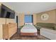 Relaxing bedroom featuring a bed, sofa, TV, and beach-themed decor at 6804 N Ocean Blvd. # 1013, Myrtle Beach, SC 29572