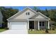Charming single-Gathering home with a two-car garage, landscaped front yard, and neutral-colored siding at 7119 Shooting Star Way, Myrtle Beach, SC 29579