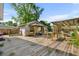 A wooden deck and backyard featuring mature trees, an outbuilding, and partially covered space at 719 Juniper Dr., Myrtle Beach, SC 29575
