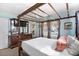 Bedroom with four poster bed, floral curtains, and antique dresser at 719 Juniper Dr., Myrtle Beach, SC 29575