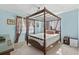 A bedroom with blue walls and floral curtains featuring a four poster bed at 719 Juniper Dr., Myrtle Beach, SC 29575