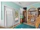Bonus room with aqua colored walls and ceiling, furniture, desk, two windows, and access to a patio at 719 Juniper Dr., Myrtle Beach, SC 29575