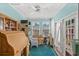 Bonus room with aqua colored walls and ceiling, furniture, desk, two windows, and access to a patio at 719 Juniper Dr., Myrtle Beach, SC 29575