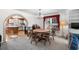 Cozy dining area with a chandelier, view into the kitchen, and natural light from the large window at 719 Juniper Dr., Myrtle Beach, SC 29575
