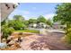 Spacious front yard with brick paved areas, lush greenery, and neighboring homes in a tranquil setting at 719 Juniper Dr., Myrtle Beach, SC 29575